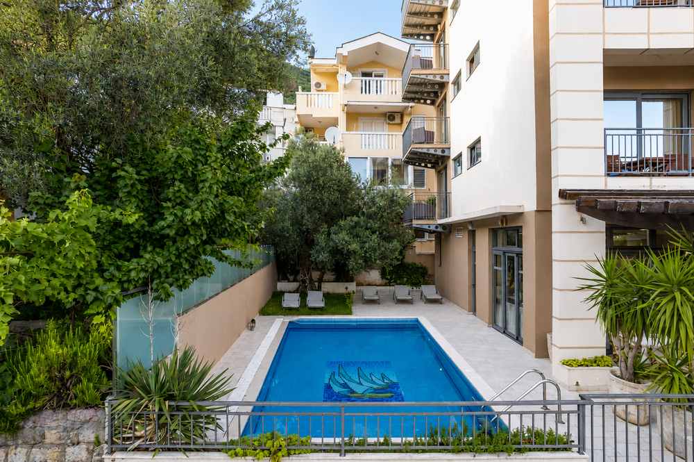 Hotel Petrovac exterior with palm trees and Adriatic light